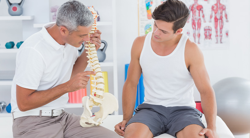 chiropractor explaining to patient